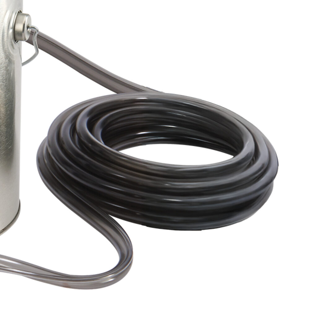 Coiled dark hose connected to metallic container on white background.