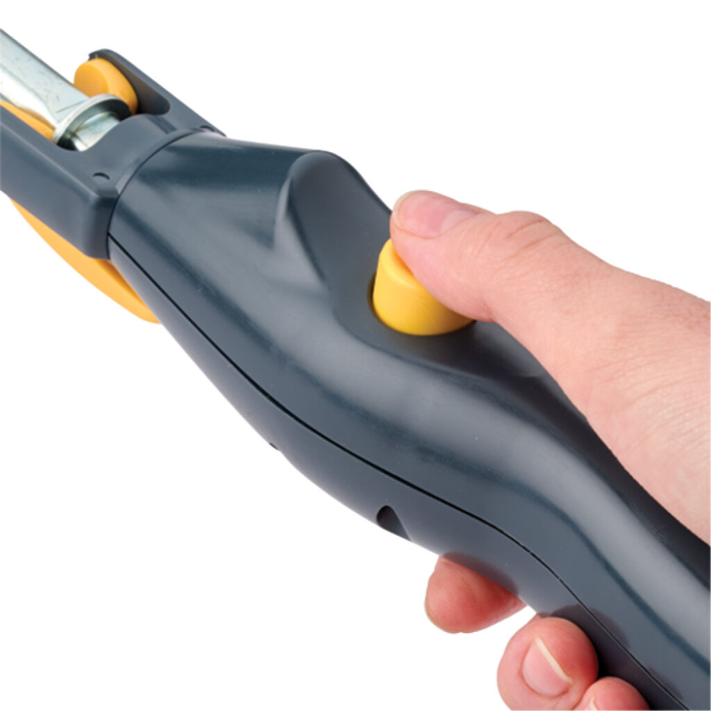 Hand pressing yellow button on dark gray tool handle.